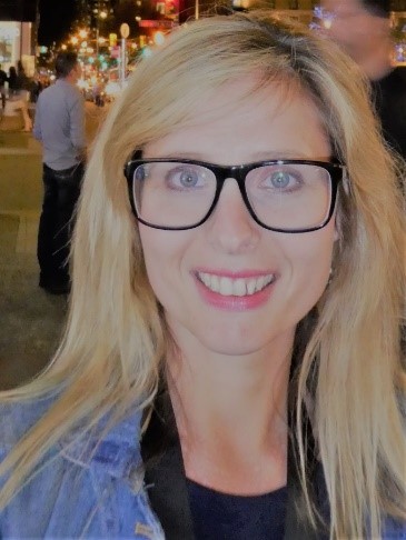 photo of Julie Ellis, who has long blonde hair, glasses, and is smiling.