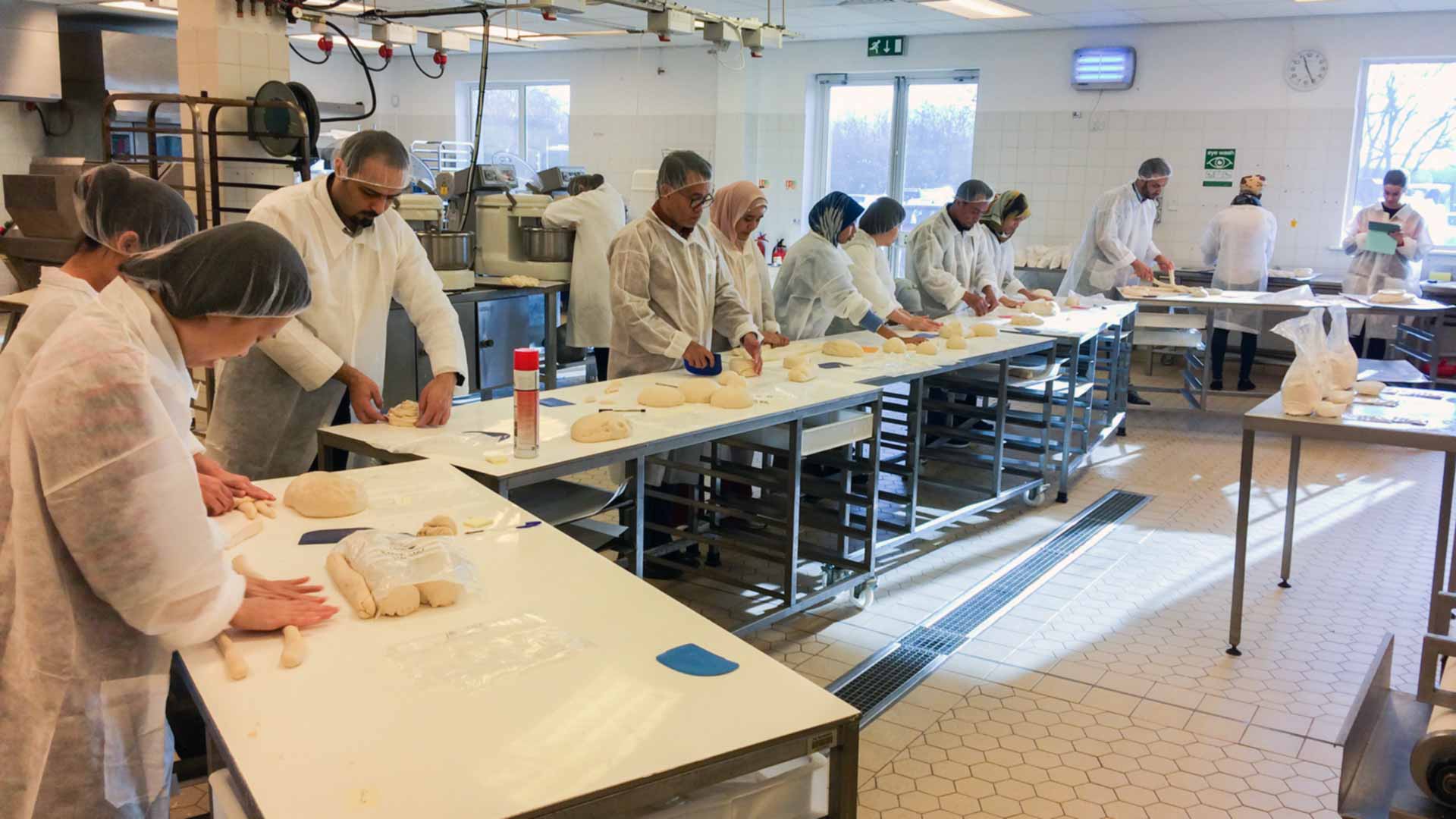 Participants in a previous Bubbles in Food conference workshop working with bread