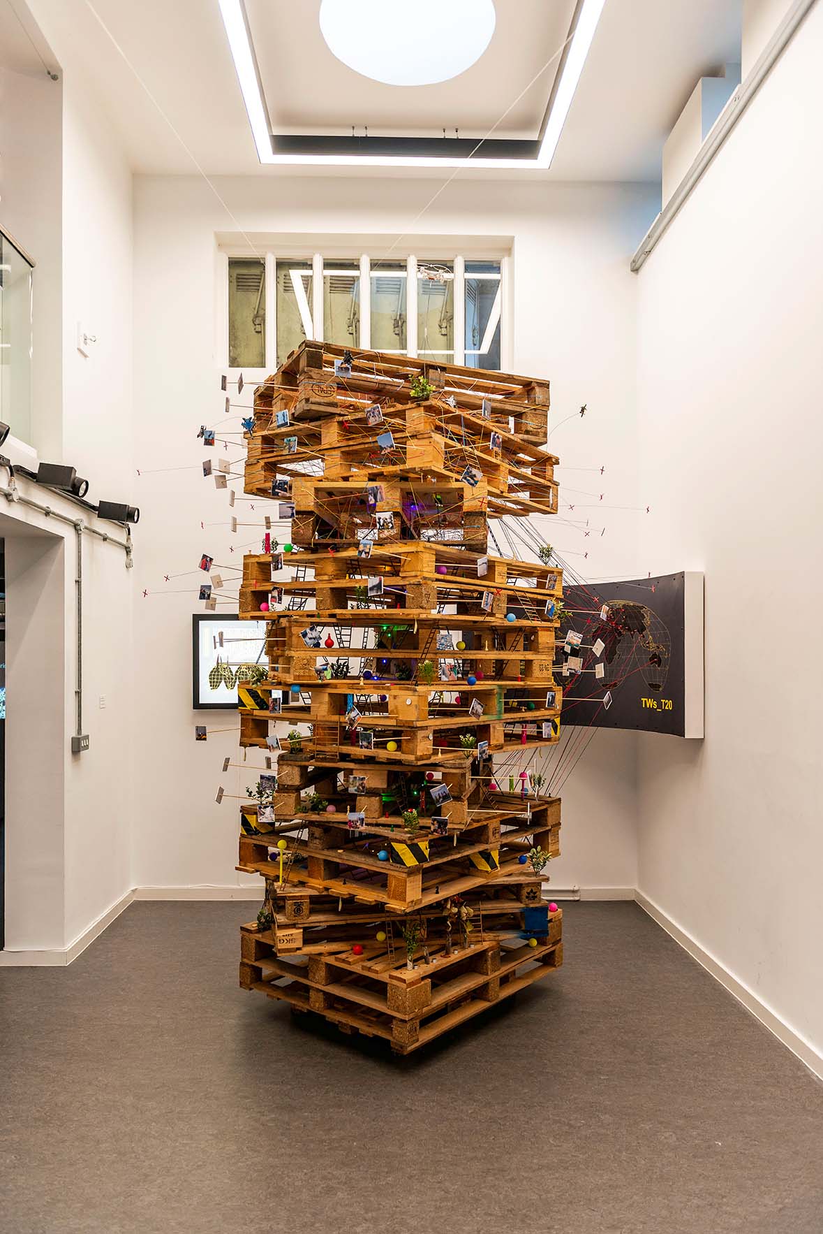 A tower of palettes stacked on top of each other with small items stacked inside them.