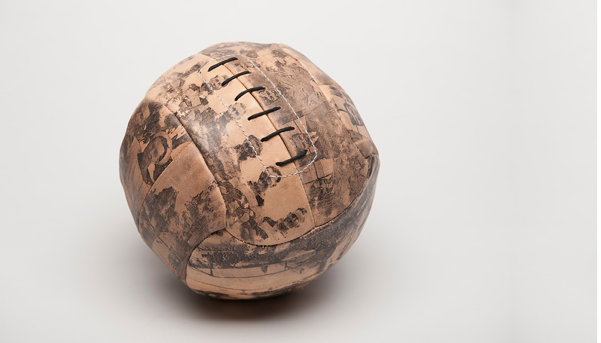 A football made of leather with old images printed on it