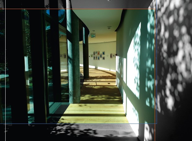 A section of corridor in a museum with images on the wall