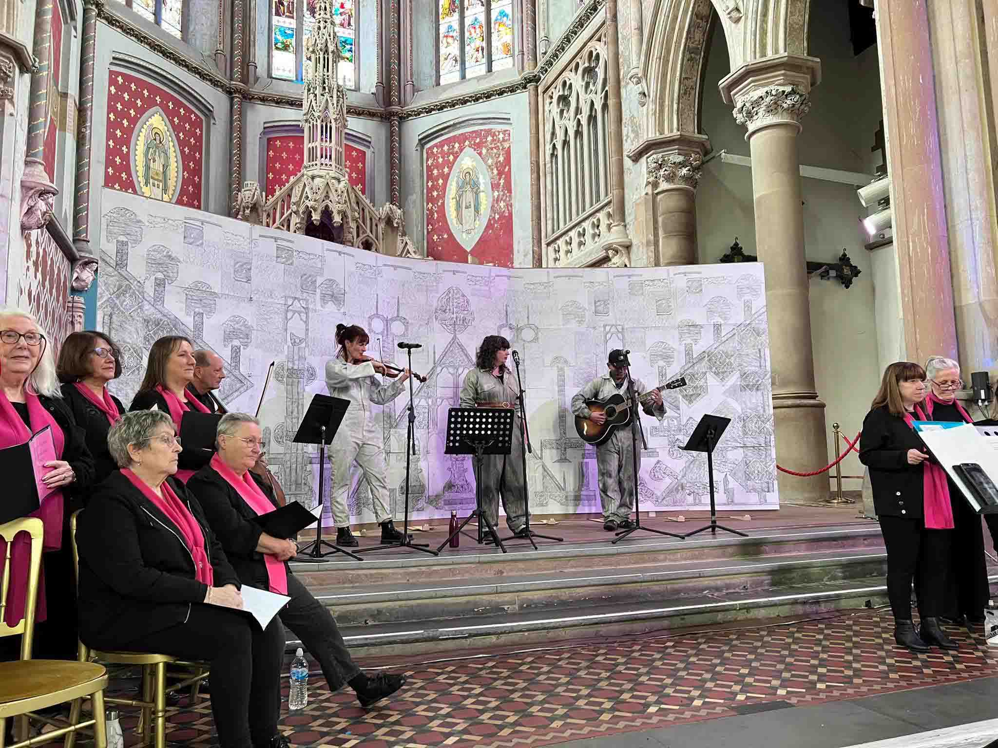 Three musicians performing on a stage in a monastrey