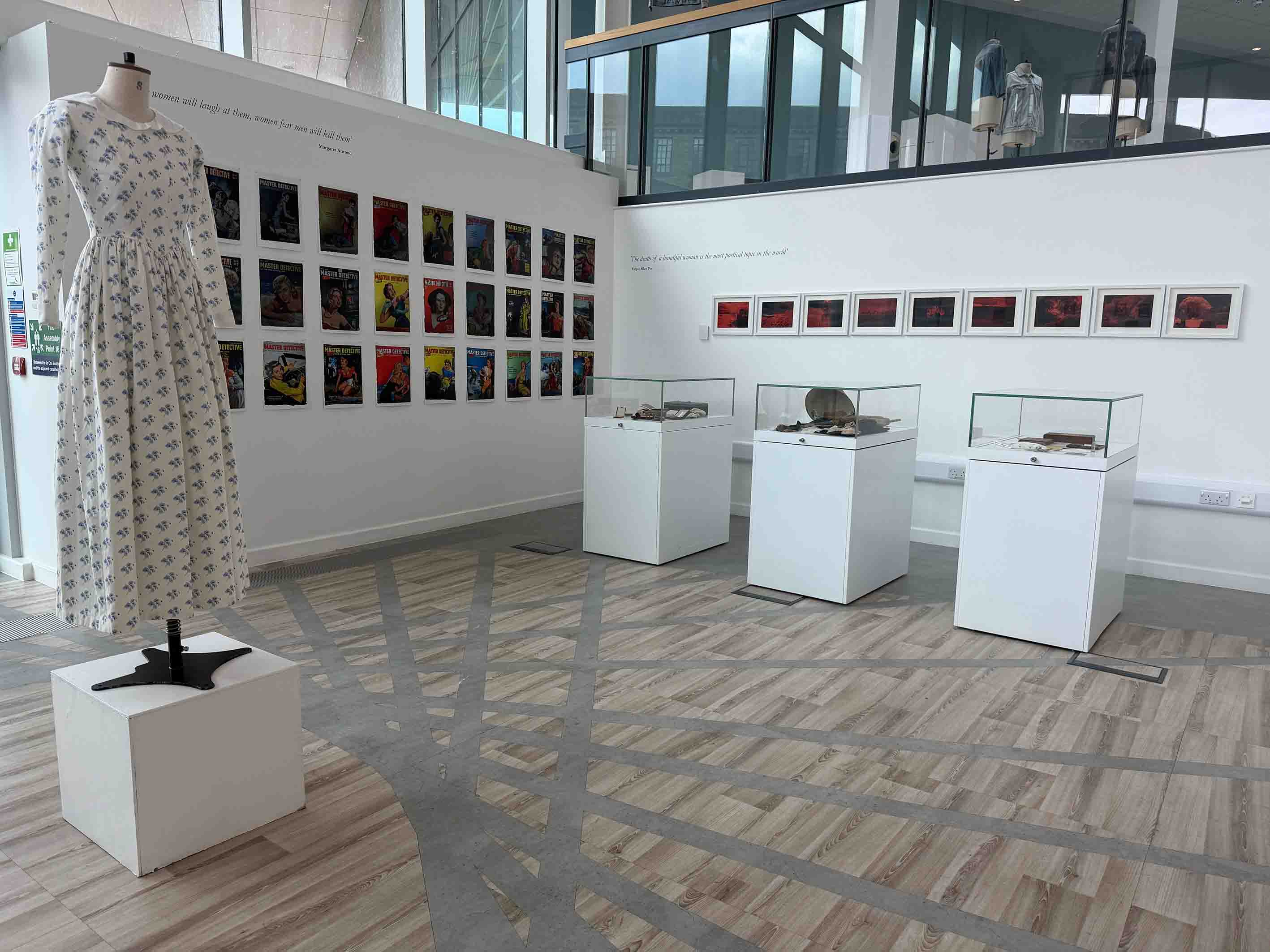 Photo of an exhibition of a dress and some posters