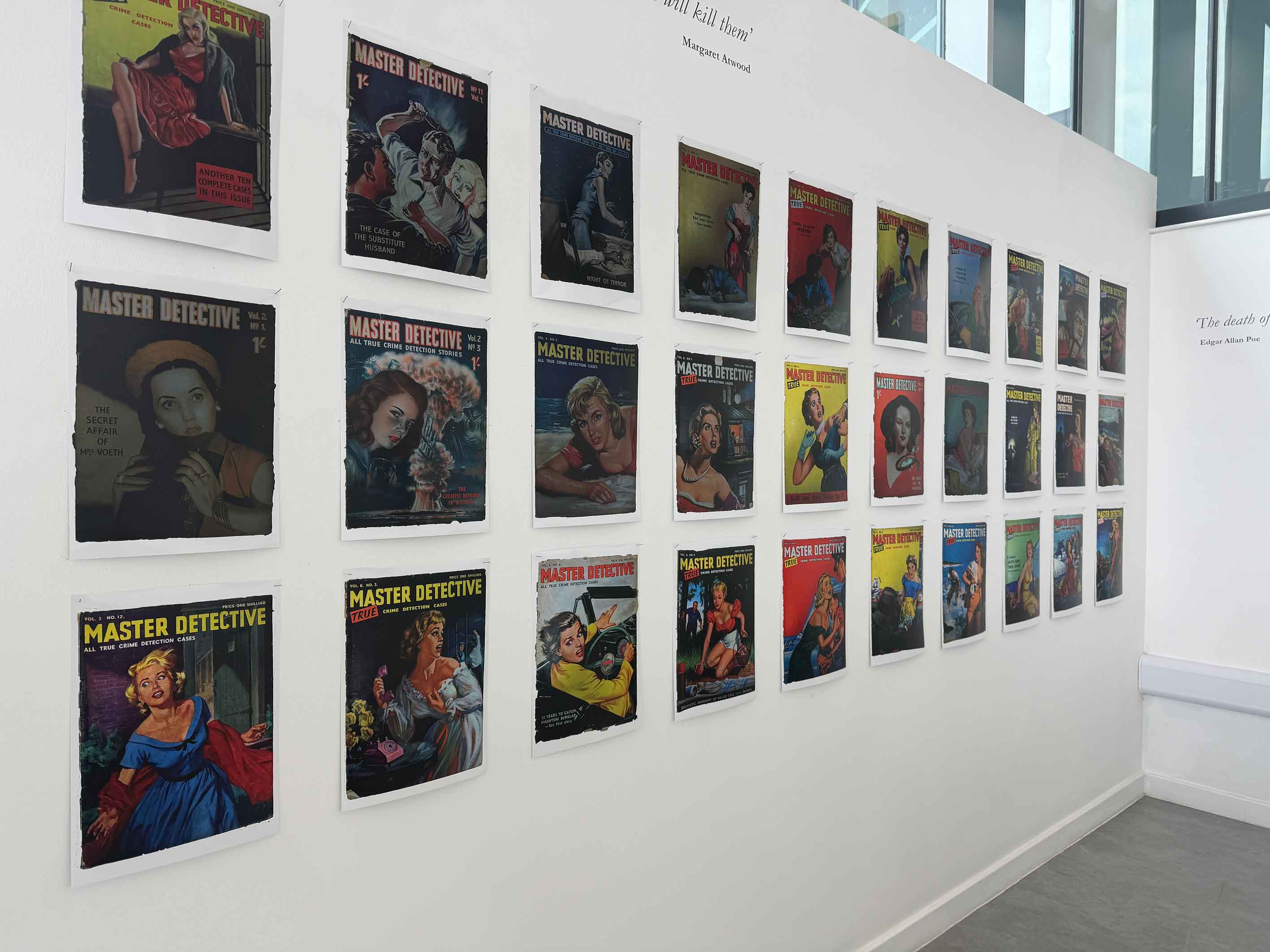 A white wall with posters