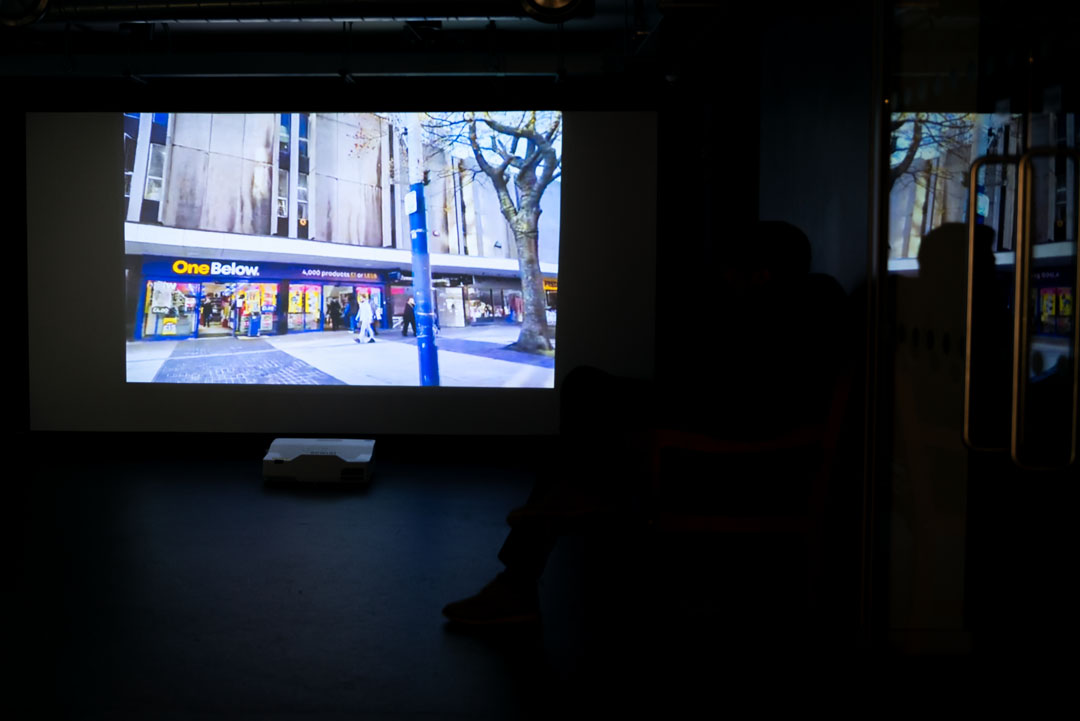 Silhoutte of person watching a projected film