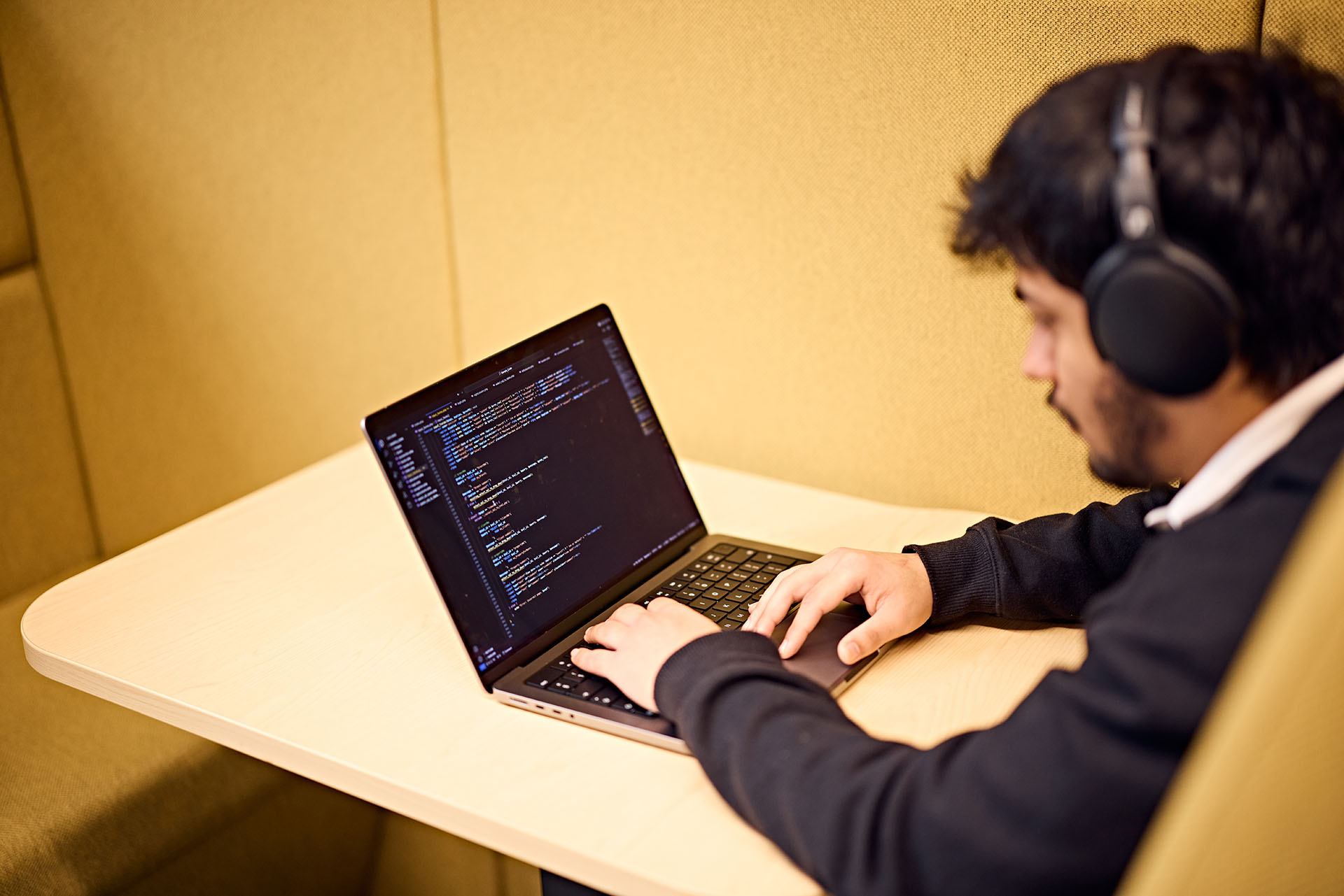 Student coding on a laptop