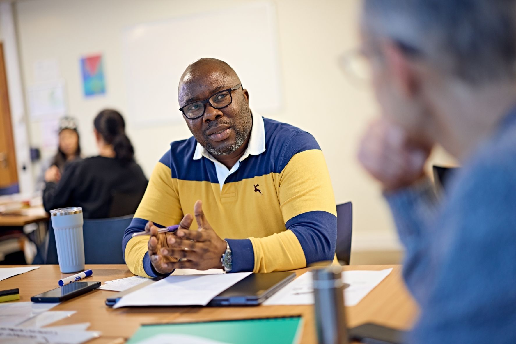 Mature student in seminar listening to group discussions