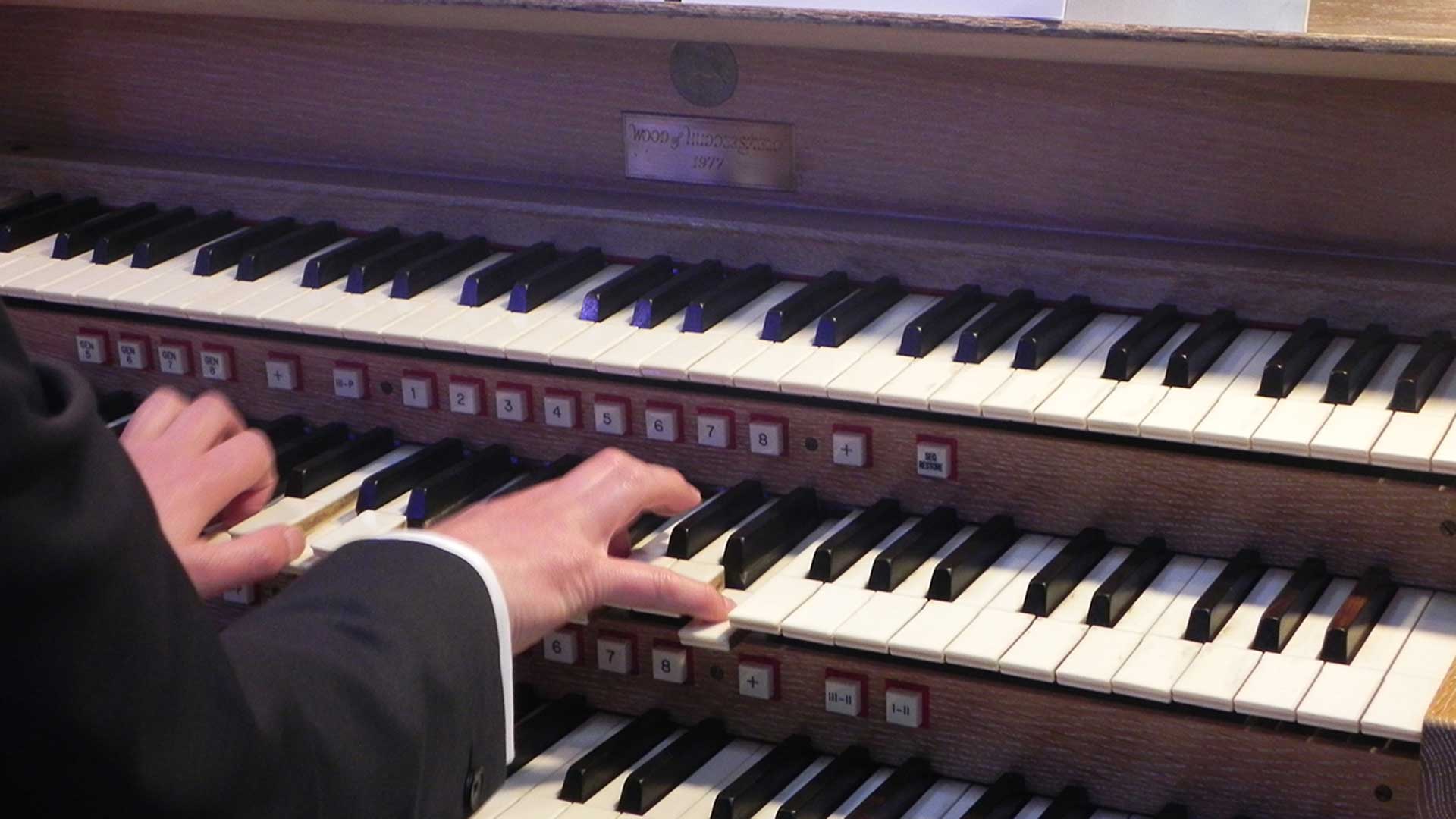 A man playing an organ.