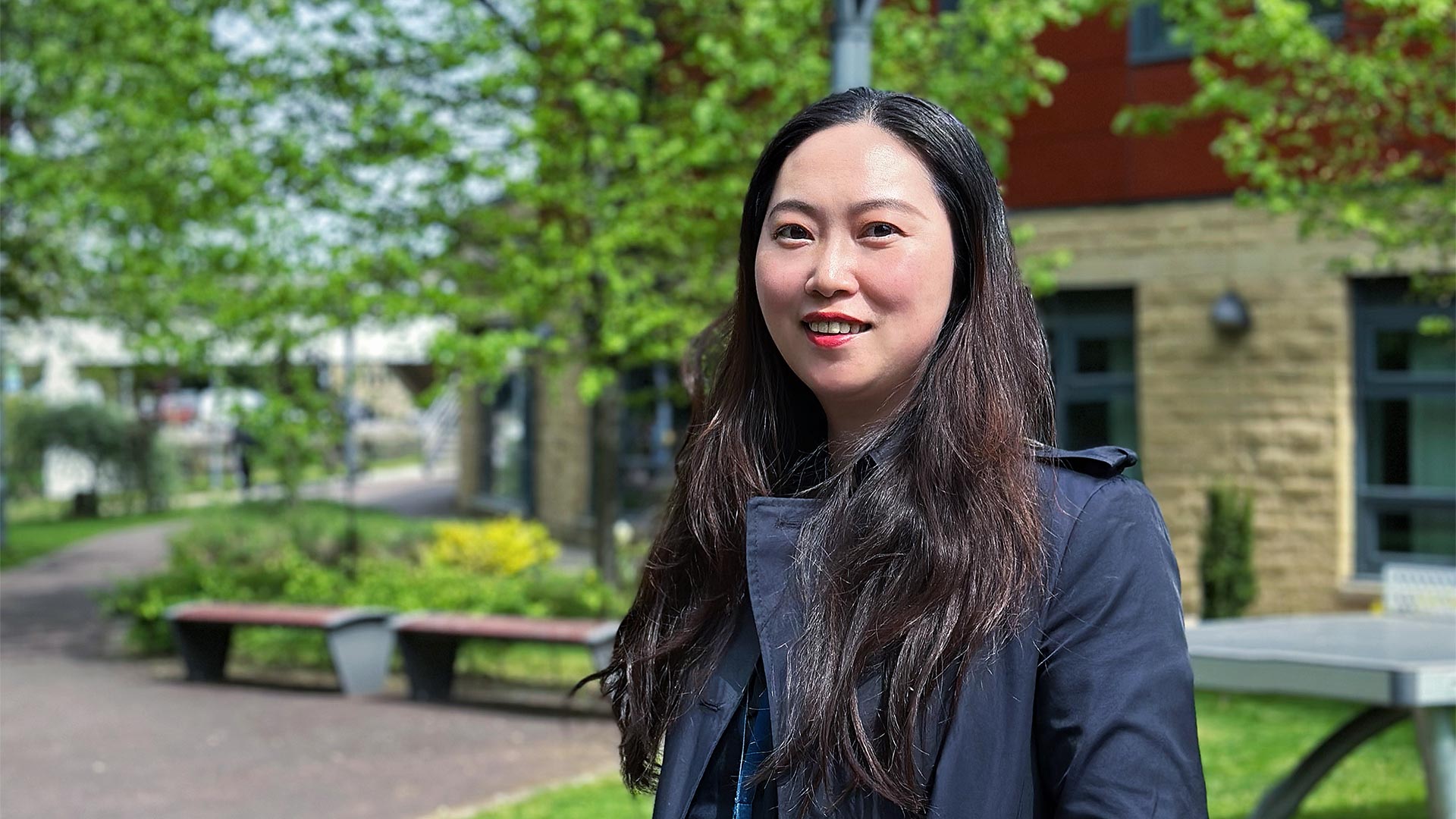 Dr Jialin (Snow) Wu outside a University of Huddersfield building
