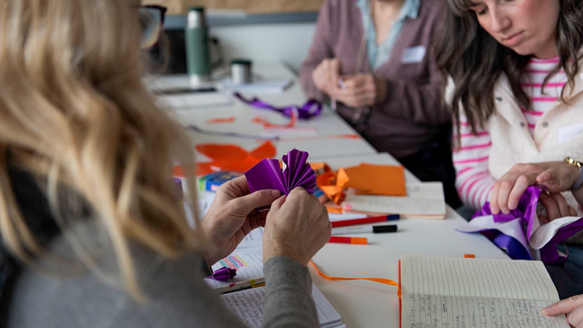 people doing crafts at a table