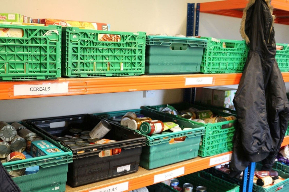 Foodbank shelving including cereals, jars and cans of food