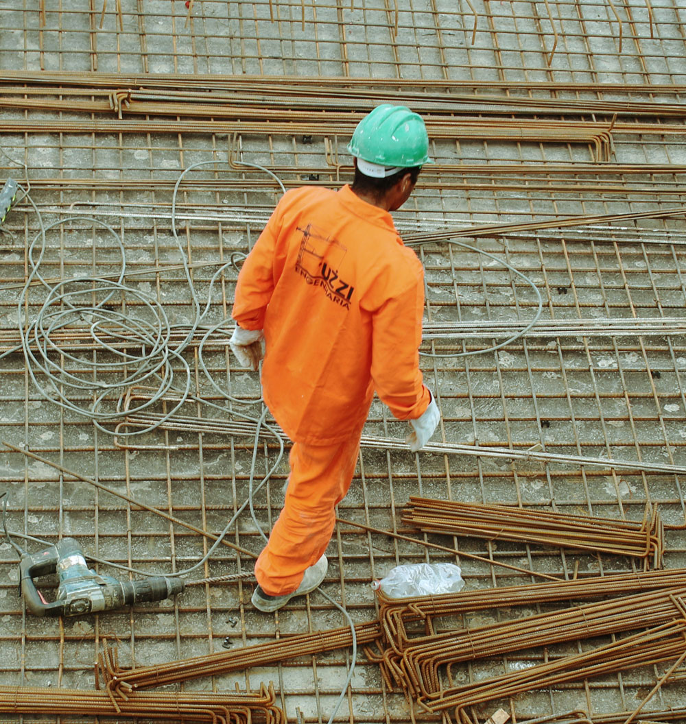 Photo of a person wearing high visibility clothing and a hard hat.